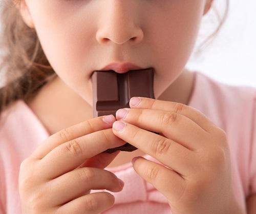 small child eating chocolate